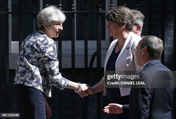 Britain's Prime Minister Theresa May shakes hands with Democratic Unionist Party leader Arlene Foster as they arrive for a meeting at 10 Downing...