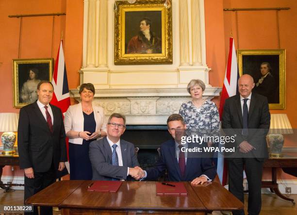 Prime Minister Theresa May stands with First Secretary of State Damian Green , Democratic Unionist Party leader Arlene Foster , DUP Deputy Leader...