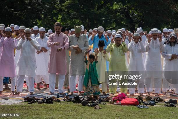 Indian Muslims perform Eid al-Fitr prayer at the Red Road in Kolkata, India on June 26, 2017. Eid al-Fitr is a religious holiday celebrated by...