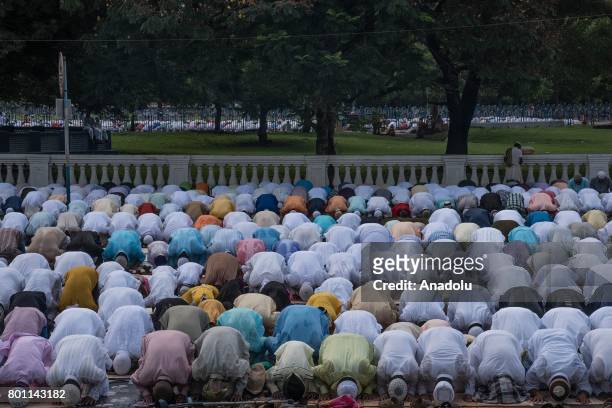 Indian Muslims perform Eid al-Fitr prayer at the Red Road in Kolkata, India on June 26, 2017. Eid al-Fitr is a religious holiday celebrated by...