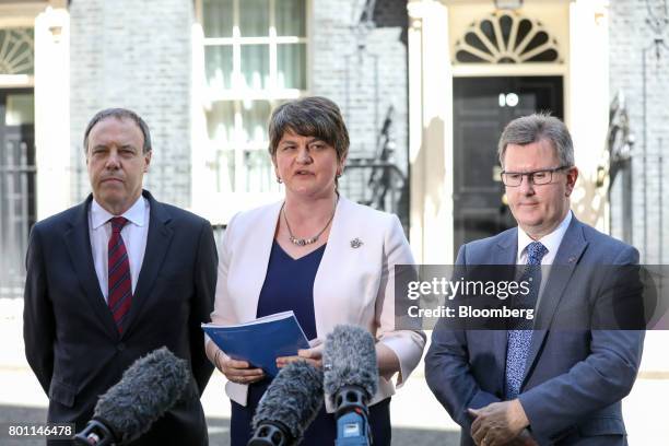 Arlene Foster, leader of the Democratic Unionist Party , center, makes a statement outside number 10 Downing Street as she is flanked by Nigel Dodds,...