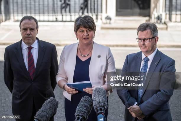 Arlene Foster , the leader of Northern Ireland's Democratic Unionist Party, party deputy leader, Nigel Dodds and MP Jeffrey Donaldson , speak to the...