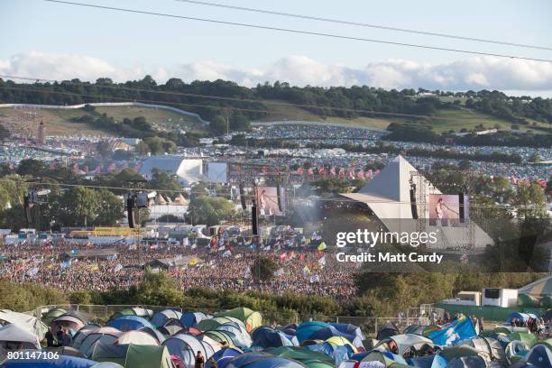 People gather in front of the Pyramid Stage at Worthy Farm in Pilton on June 25, 2017 near Glastonbury, England. Glastonbury Festival of Contemporary...
