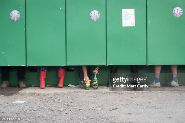 People use the toilets at the Glastonbury Festival site at Worthy Farm in Pilton on June 25, 2017 near Glastonbury, England. Glastonbury Festival of...