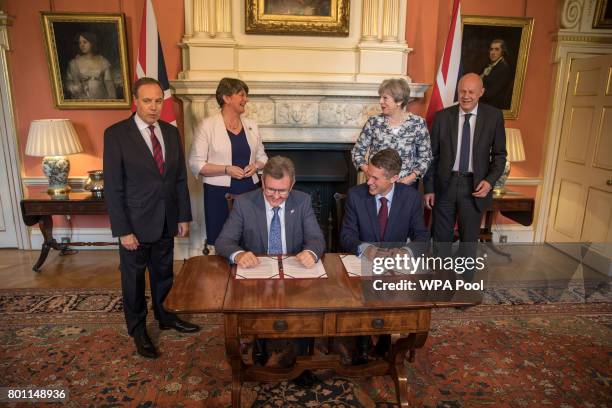 Prime Minister Theresa May stands with First Secretary of State Damian Green , Democratic Unionist Party leader Arlene Foster , DUP Deputy Leader...