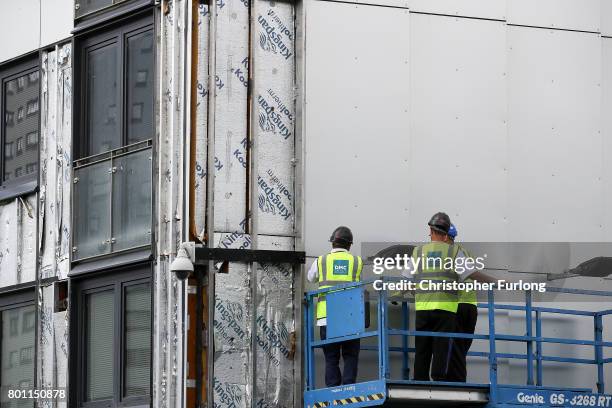 Workers remove cladding for testing from one of the tower blocks in Salford City on June 26, 2017 in Salford, England. In the wake of the Grenfell...