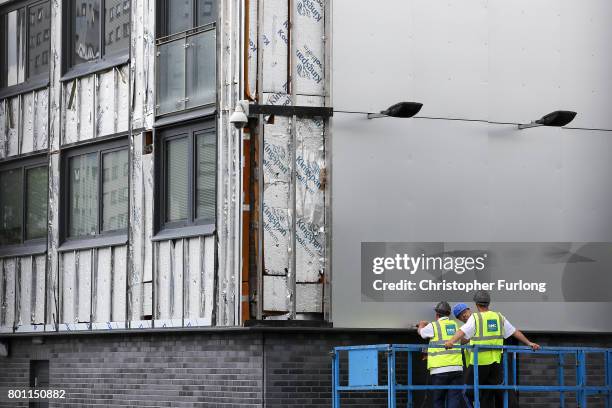 Workers remove cladding for testing from one of the tower blocks in Salford City on June 26, 2017 in Salford, England. In the wake of the Grenfell...