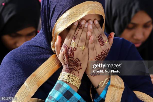 Sri Lankan muslim girl prays during an Eid al-Fitr event to mark the end of the holy fasting month of Ramadan in Colombo, Sri Lanka Monday 26 June...