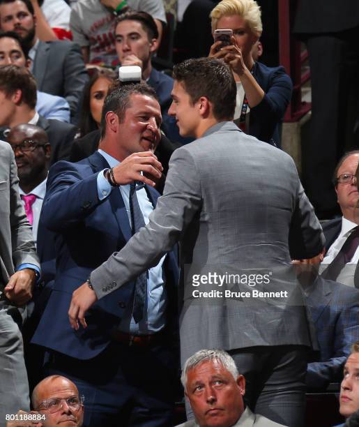 Former NHL player Adam Foote congratulates his son Callan on his selection by the Tampa Bay Lightning during the 2017 NHL Draft at the United Center...