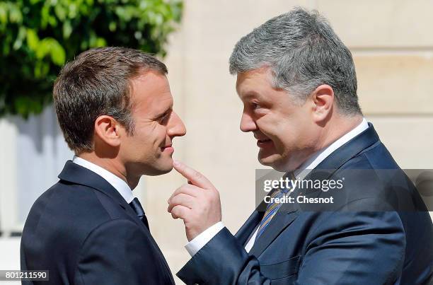 French President Emmanuel Macron welcomes Ukrainian President Petro Poroshenko prior to a meeting at the Elysee Presidential Palace on June 26, 2017...