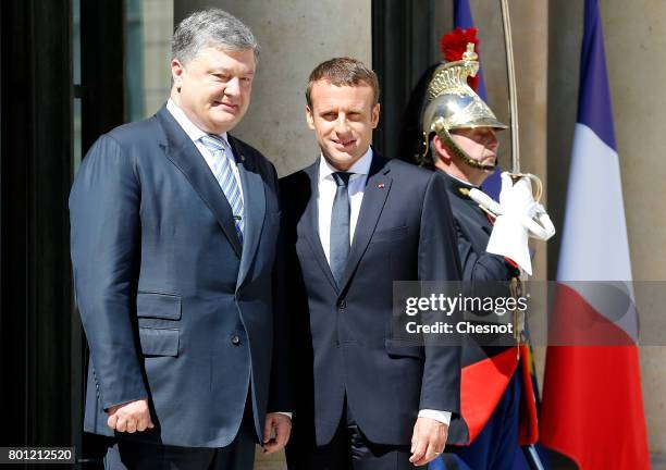 French President Emmanuel Macron welcomes Ukrainian President Petro Poroshenko prior to a meeting at the Elysee Presidential Palace on June 26, 2017...