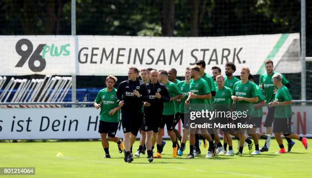 The team of Hannover 96 warms up before a Hannover 96 training session at HDI-Arena on June 26, 2017 in Hanover, Germany.