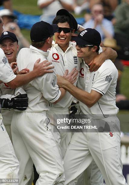 Teammates run in to congratulate Alastair Cook of England after he took a catch to dismiss Stephen Fleming of New Zealand during the first Test match...