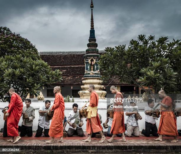 alms giving ceremony luang prabang laos - luang prabang stock pictures, royalty-free photos & images