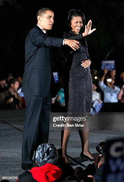 Democratic presidential hopeful Sen. Barack Obama and his wife Michelle Obama greet supporters as they arrive to a primary campaign rally outside the...