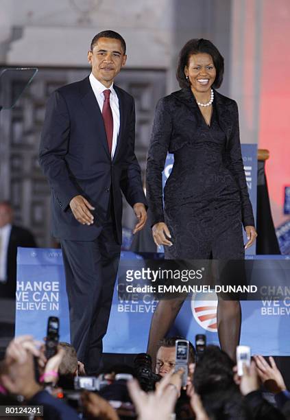 Democratic presidential candidate Illinois Senator Barack Obama arrives on stage with his wife Michelle during a primary night results rally in San...