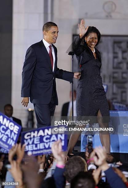 Democratic presidential candidate Illinois Senator Barack Obama and his wife Michelle wave to supporters during a primary night results rally in San...