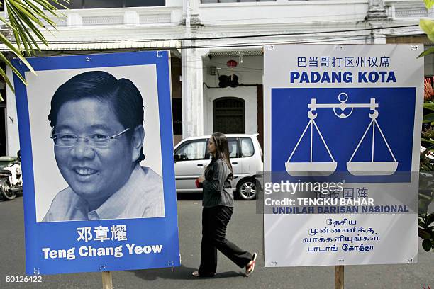Malaysia-vote-Chinese by M. Jegathesan A pedestrian walks past campaign material for an ethnic Chinese candidate with the ruling Barisan Nasional...