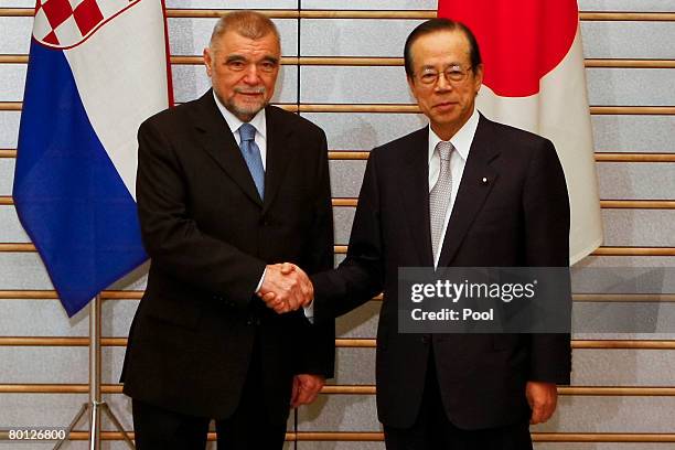 Croatian President Stjepan Mesic is greeted by Japanese Prime Minister Yasuo Fukuda prior to their talks at Fukuda's office March 5, 2008 in Tokyo,...