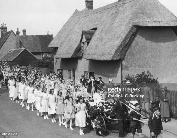 May Day parade in the village of Elstow, Bedfordshire, 3rd May 1934. The May Queen on the carriage is local schoolgirl Doris Curnow.