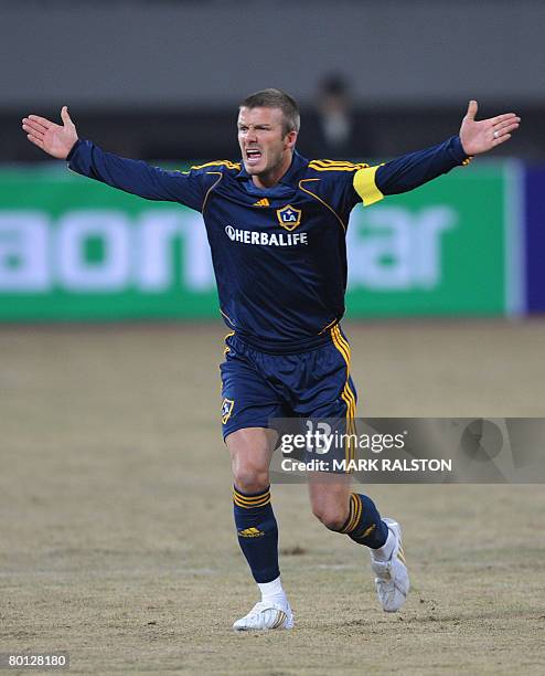 English football star David Beckham from the LA Galaxy team, appeals for a penalty during their exhibition match against a joint Shanghai-Hong Kong...