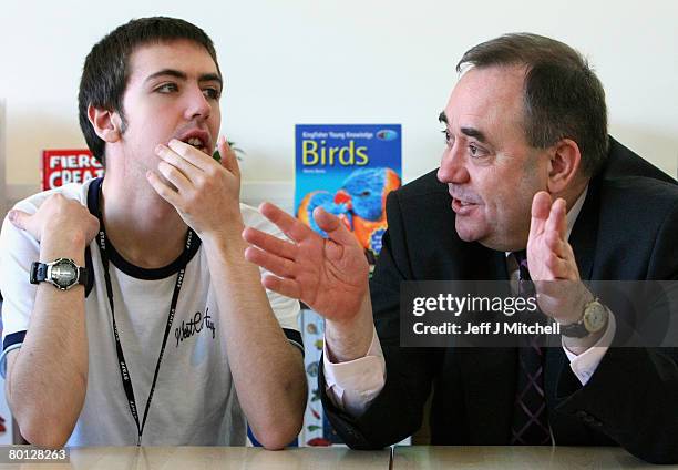 Scotland's First Minister Alex Salmond, talks with Jonathan, a pupil at New Struan School centre for autism on March 5, 2008 in Alloa, Scotland....