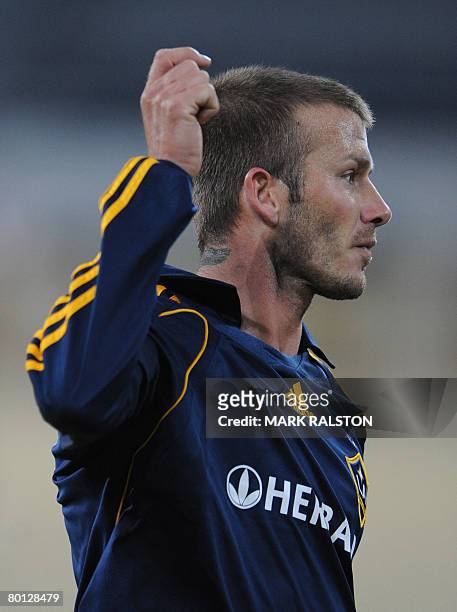 English football star David Beckham from the LA Galaxy team, celebrates after assisting a goal during their exhibition match against a joint...