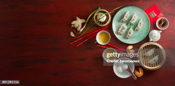 chinese new year food and drink on red rustic background. - lunar new year cup 2017 stock-fotos und bilder