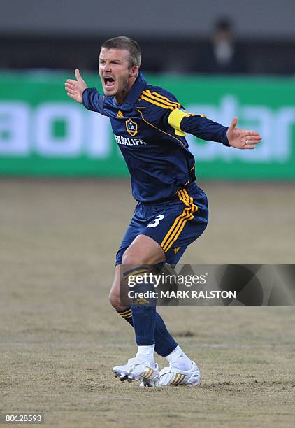 English football star David Beckham from the LA Galaxy team, appeals for a penalty during their exhibition match against a joint Shanghai-Hong Kong...