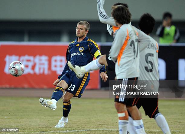 English football star David Beckham from the LA Galaxy team, takes a penalty kick during their exhibition match which they won 3-0 against a joint...