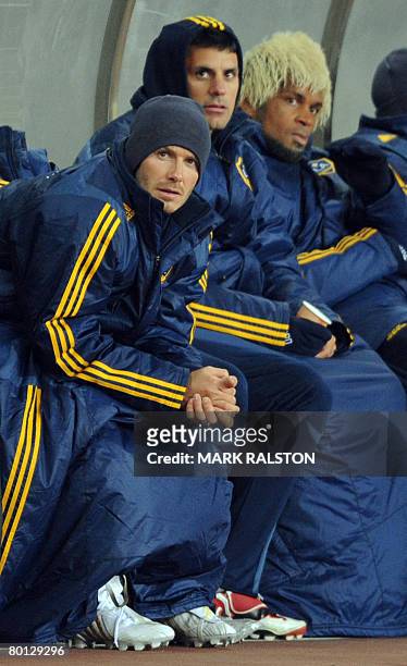 English football star David Beckham from the LA Galaxy team, watches from the bench after he was substituted during their exhibition match which they...