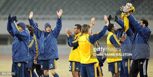 English football star David Beckham from the LA Galaxy team, celebrates with teammates after winning their exhibition match 3-0 against a joint...