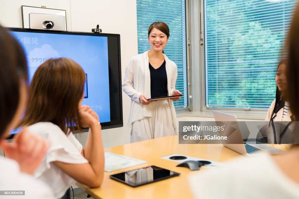 Businesswoman leading meeting in a conference room