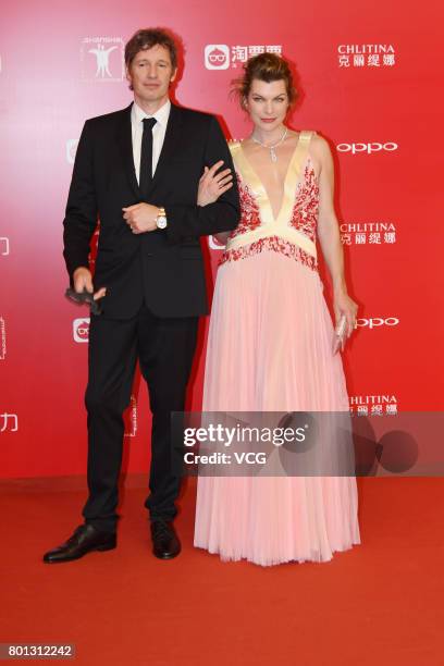 English director Paul William Scott Anderson and his wife American actress Milla Jovovich arrive at red carpet of Golden Goblet Awards and Closing...