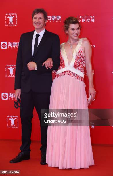 English director Paul William Scott Anderson and his wife American actress Milla Jovovich arrive at red carpet of Golden Goblet Awards and Closing...