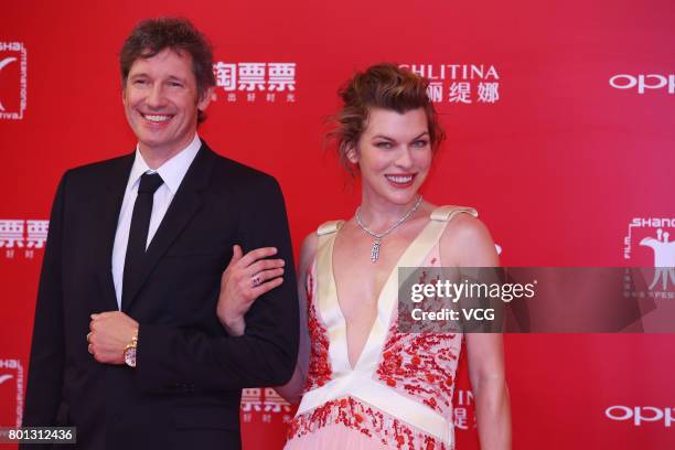 English director Paul William Scott Anderson and his wife American actress Milla Jovovich arrive at red carpet of Golden Goblet Awards and Closing...