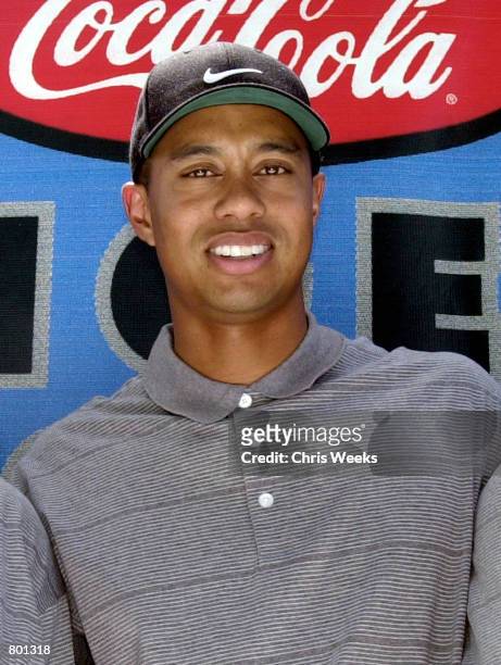 Professional golfer Tiger Woods poses for photographers April 14, 2001 at the Coca-Cola Tiger Woods Foundation Junior Golf Clinic at the El Dorado...