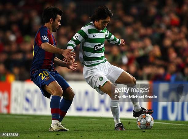 Shunsuke Nakamura of Celtic holds back Deco of Barcelona during the UEFA Champions League 2nd leg of the First knockout round match between FC...