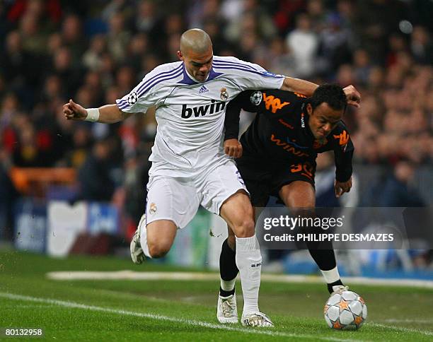 Roma's Mancini Amantino fights for the ball with Real Madrid's Pepe during a Champions league return leg football match at the Santiago Bernabeu...