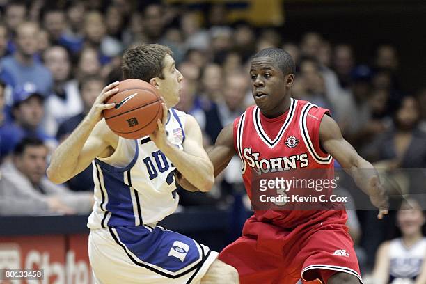 Greg Paulus of the Duke Blue Devils looks to move the ball against Malik Boothe of the St. John's Red Storm during the game at Cameron Indoor Stadium...