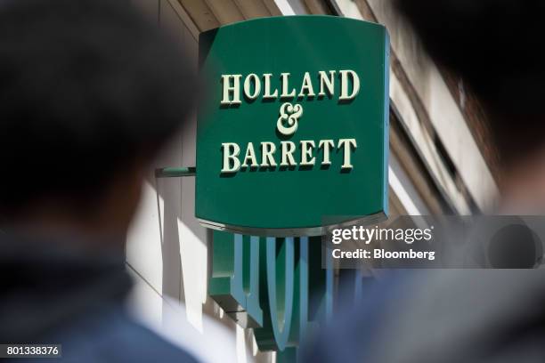 Pedestrians pass a store operated by Holland & Barrett Retail Ltd. On Oxford Street in London, U.K., on Monday, June 26, 2017. Russian...