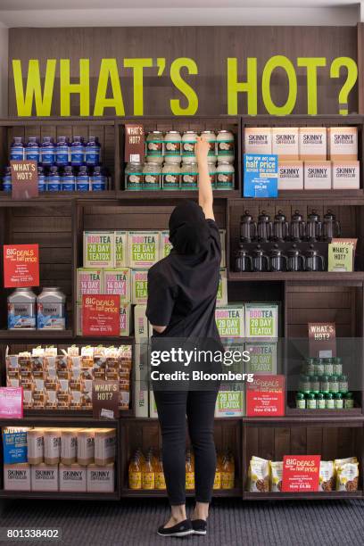 An employee checks produce at a store operated by Holland & Barrett Retail Ltd. On Oxford Street in London, U.K., on Monday, June 26, 2017. Russian...