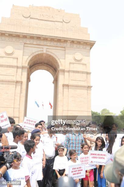 Bollywood actor Siddharth Malhotra along with DCP Traffic AK Singh and school children participates during a Delhi road safety activity to spread...