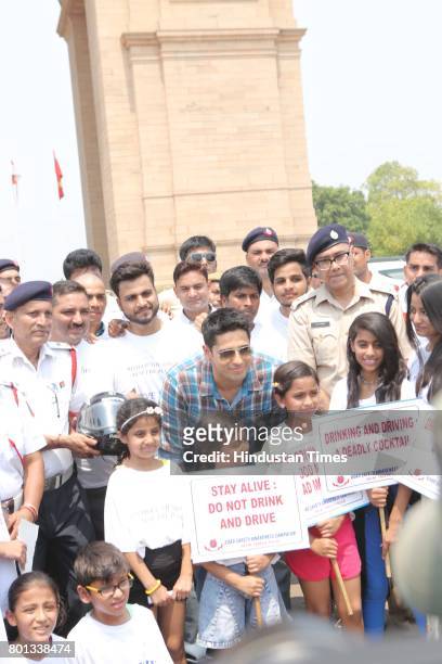 Bollywood actor Siddharth Malhotra along with DCP Traffic AK Singh and school children participates during a Delhi road safety activity to spread...