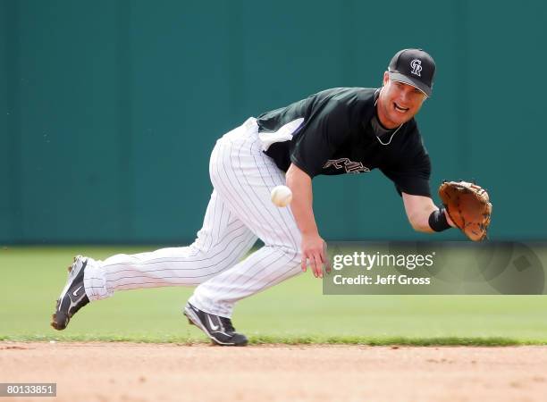 Second baseman Jayson Nix of the Colorado Rockies dives for a ball in the second inning during a spring training game against the Chicago White Sox...
