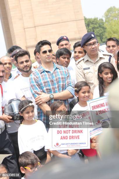 Bollywood actor Siddharth Malhotra along with DCP Traffic AK Singh and school children participates during a Delhi road safety activity to spread...