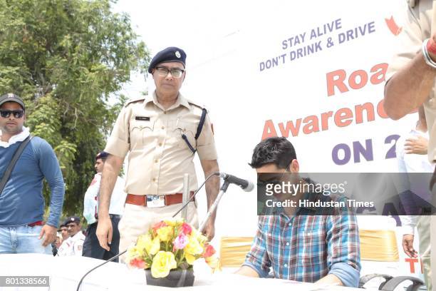 Bollywood actor Siddharth Malhotra along with DCP Traffic AK Singh and school children participates during a Delhi road safety activity to spread...