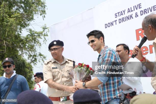 Bollywood actor Siddharth Malhotra along with DCP Traffic AK Singh and school children participates during a Delhi road safety activity to spread...