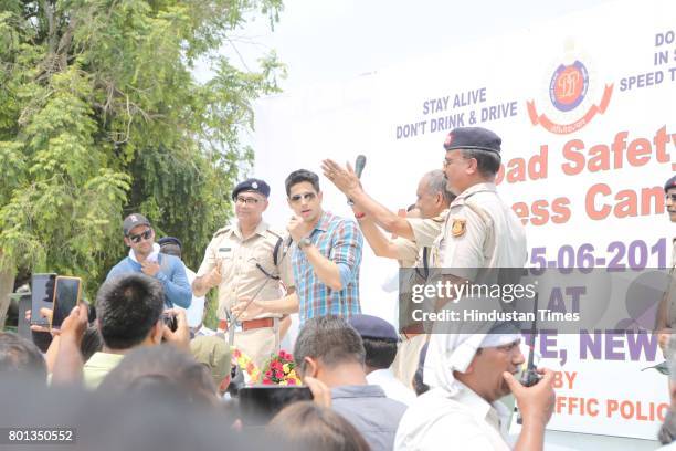 Bollywood actor Siddharth Malhotra along with DCP Traffic AK Singh and school children participates during a Delhi road safety activity to spread...