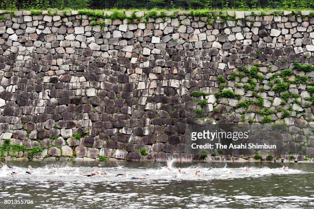 Participants swim at a moat during the Osaka Castle Triathlon on June 25, 2017 in Osaka, Japan.